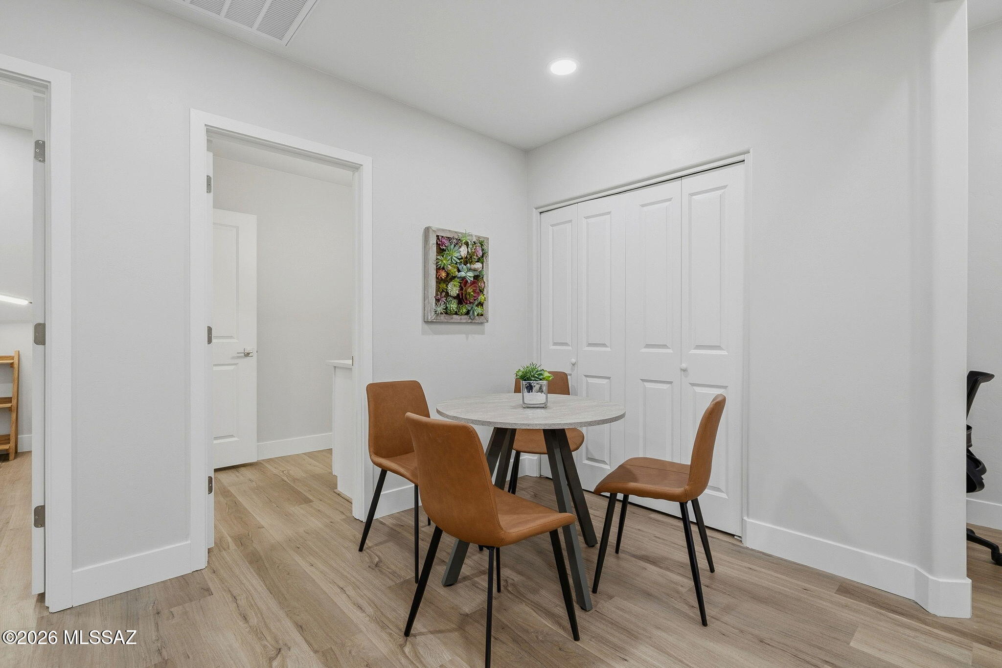 2020 East River Road, Unit 101 Tucson, AZ 85718 - Photo 6 of 12 a view of a dining room with furniture and wooden floor