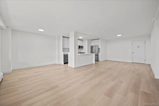 a view of a kitchen with a sink and a refrigerator