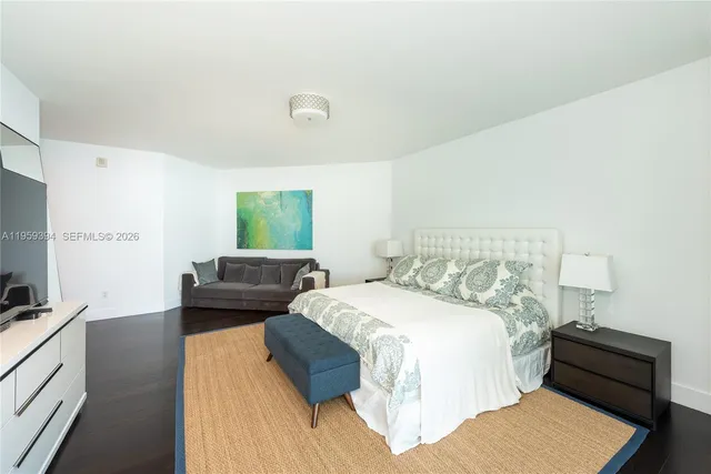 a bedroom with a bed and a couch