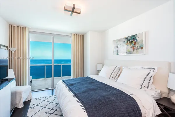 a bedroom with a bed and a view of bathroom