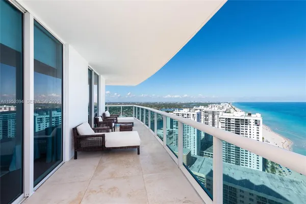 a balcony with furniture and city view
