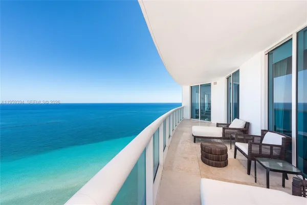 a balcony with chairs and an outdoor view