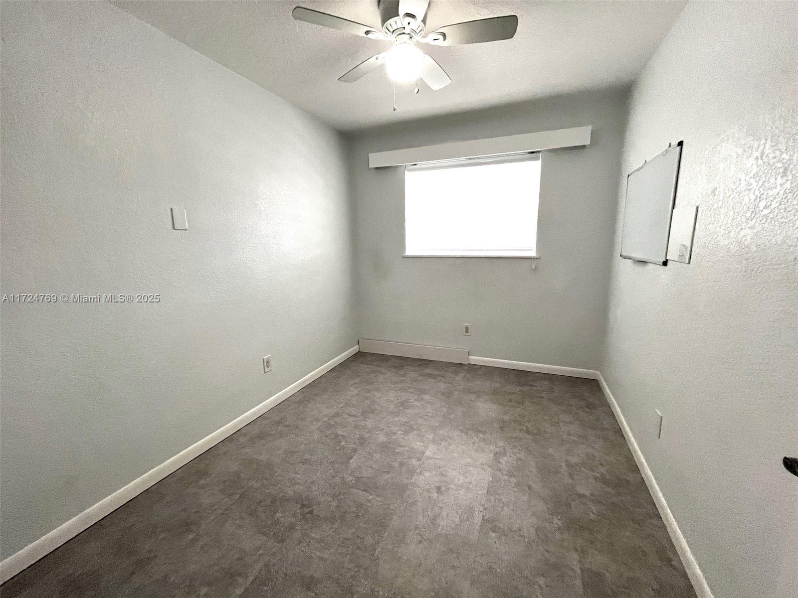 1600 North 56th Avenue Hollywood, FL 33021 - Photo 13 of 25 an empty room with a window and a ceiling fan