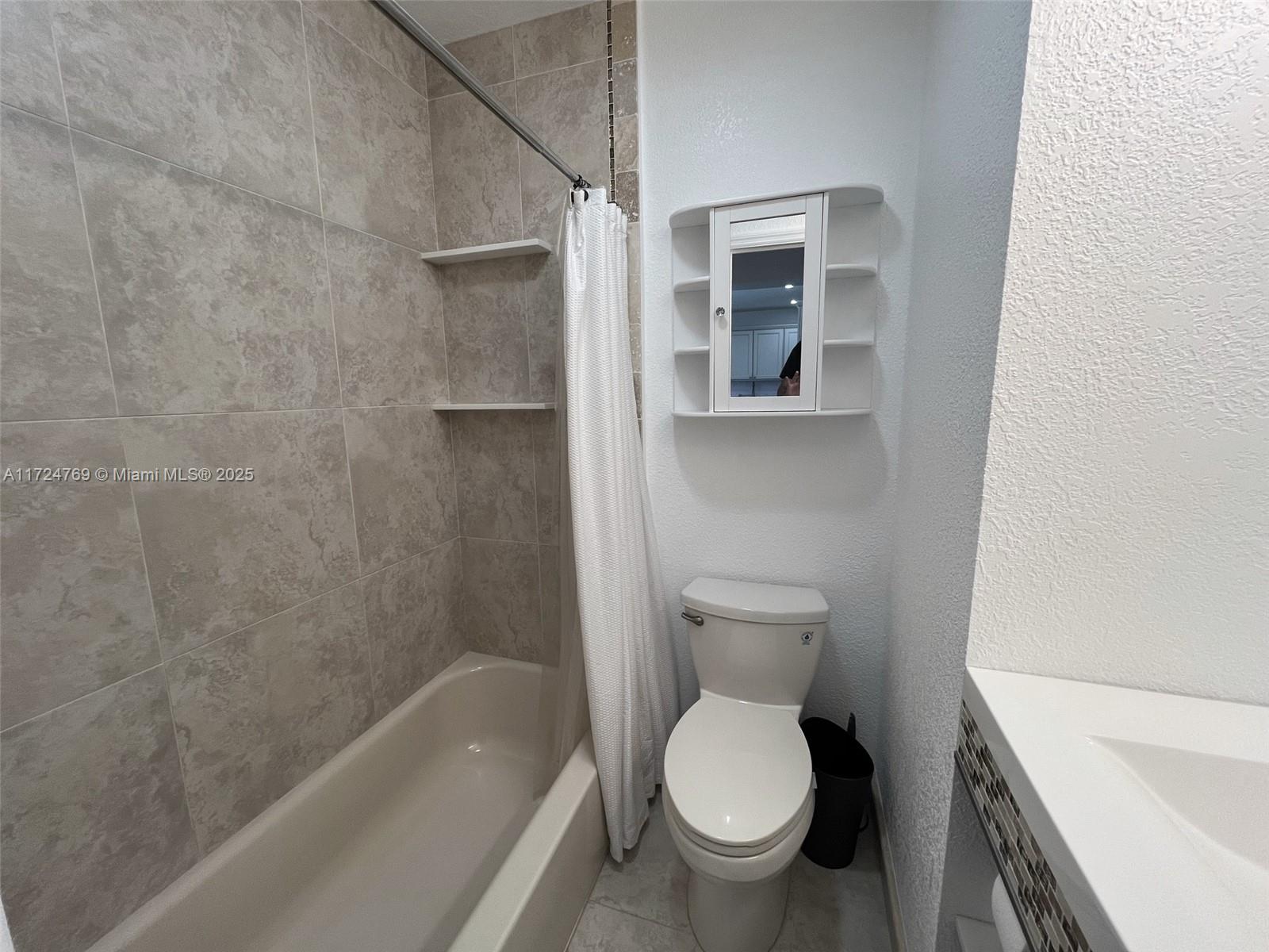 1600 North 56th Avenue Hollywood, FL 33021 - Photo 14 of 25 a bathroom with a toilet and a bathtub