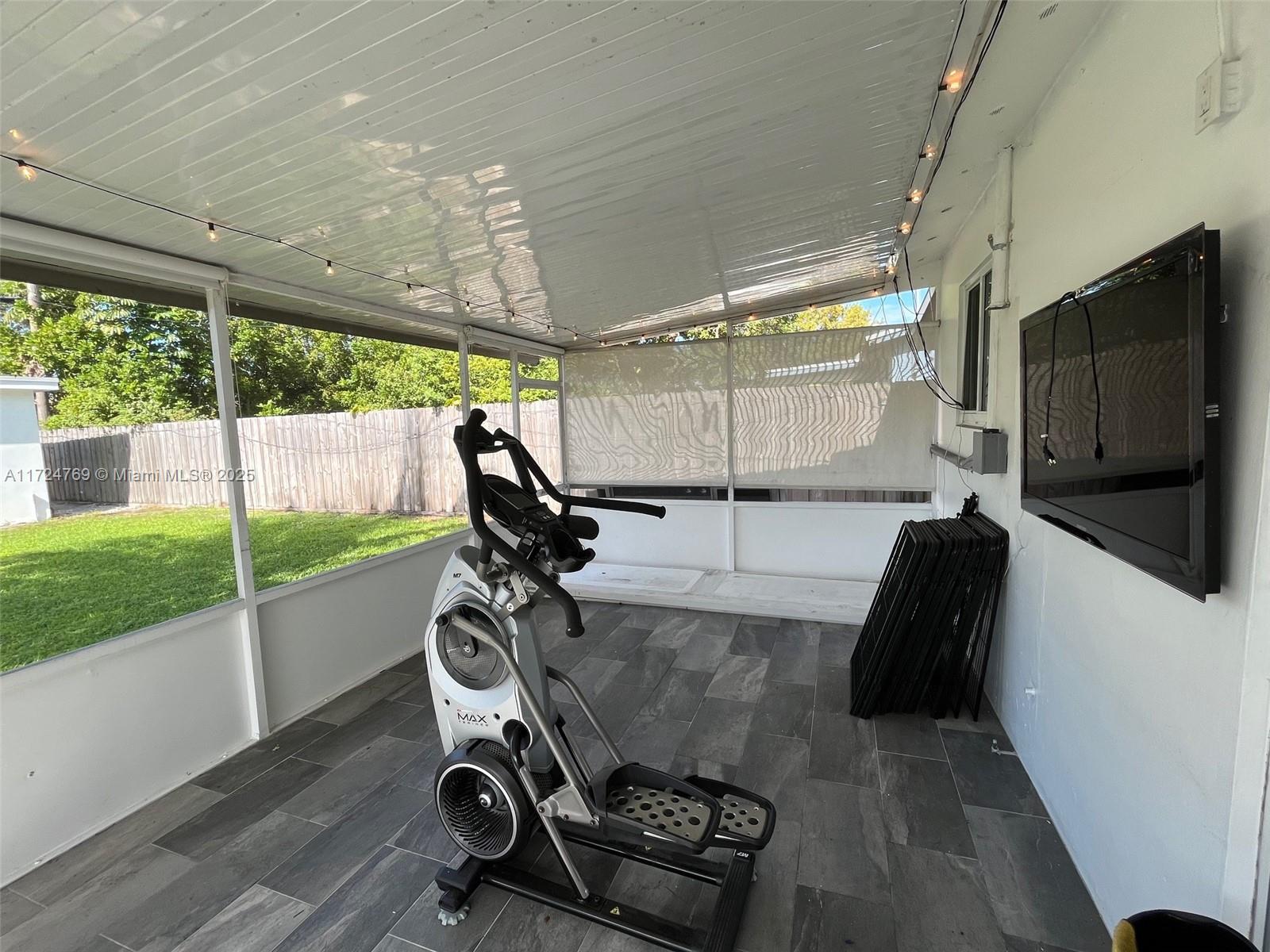 1600 North 56th Avenue Hollywood, FL 33021 - Photo 16 of 25 a room with gym equipment and a large window