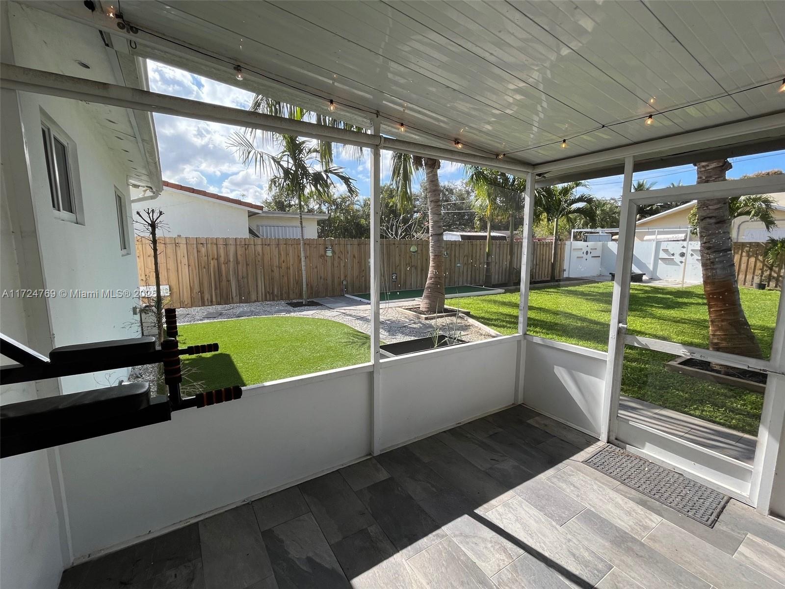 1600 North 56th Avenue Hollywood, FL 33021 - Photo 17 of 25 a view of a patio with a table chairs and a backyard
