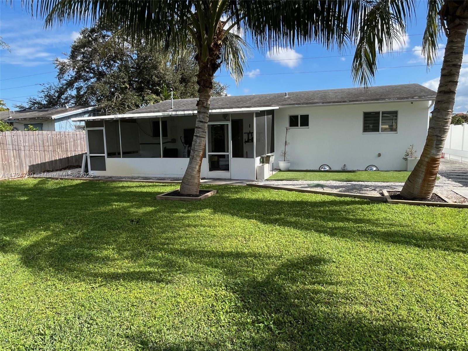 1600 North 56th Avenue Hollywood, FL 33021 - Photo 19 of 25 a backyard of a house with table and chairs