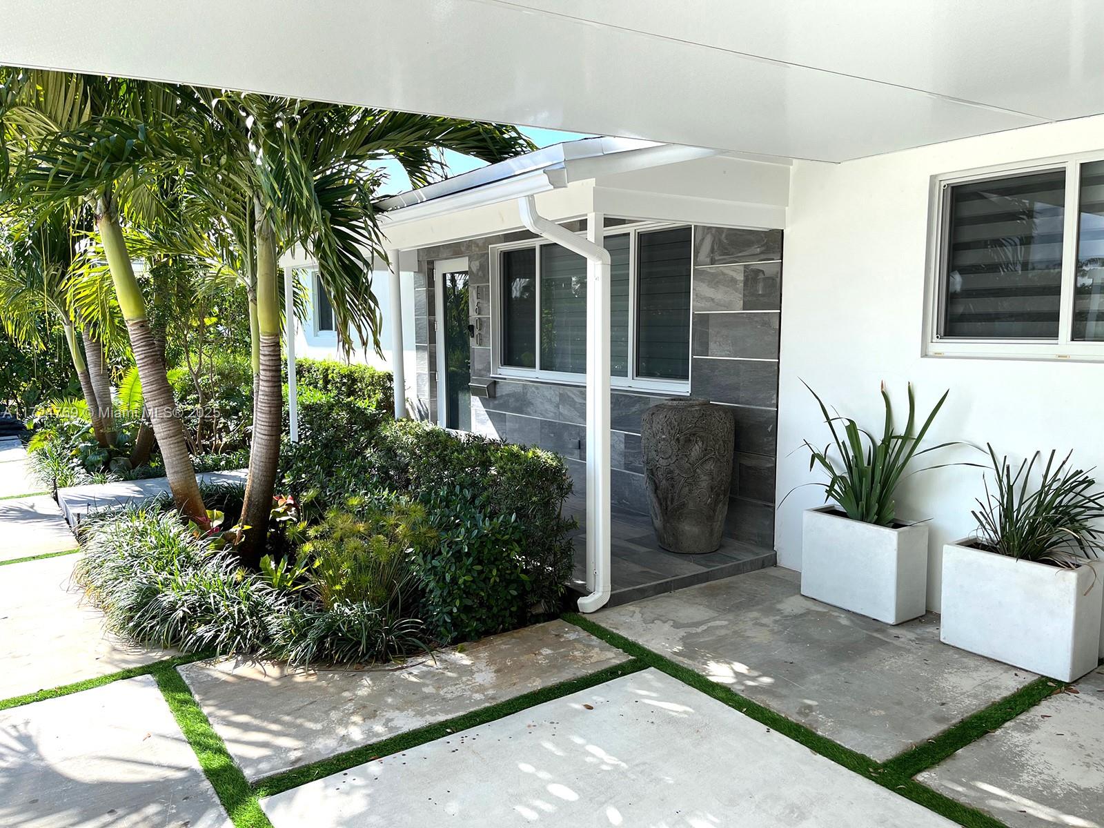 1600 North 56th Avenue Hollywood, FL 33021 - Photo 2 of 25 a front view of a house with a garden