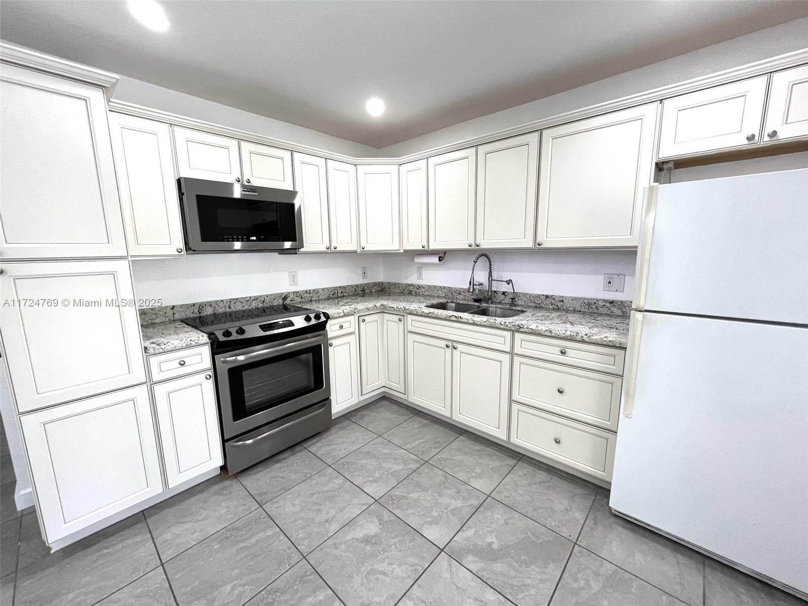 1600 North 56th Avenue Hollywood, FL 33021 - Photo 6 of 25 a kitchen with cabinets stainless steel appliances and window