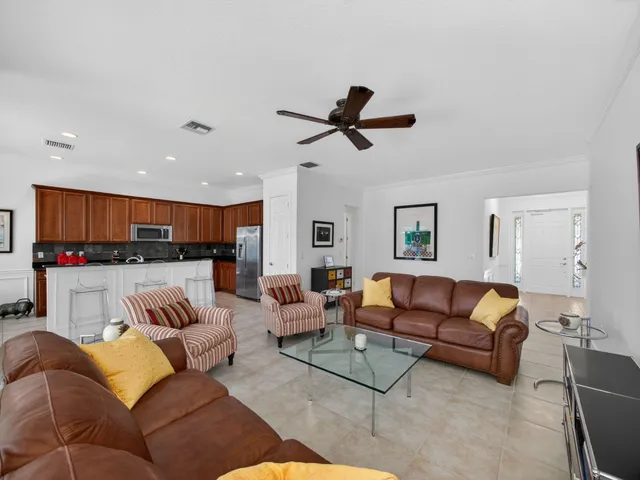 a living room with furniture kitchen view and a couch