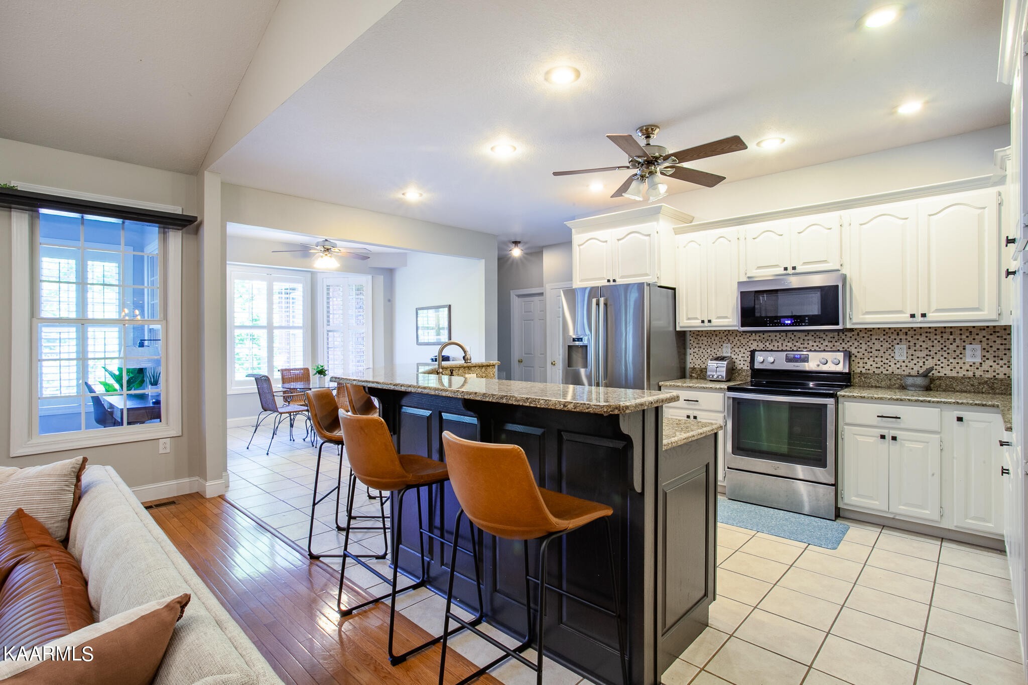 610 Dry Valley Road Townsend, TN 37882 - Photo 12 of 37 a kitchen with stainless steel appliances granite countertop a stove top oven a sink dishwasher a dining table and chairs with wooden floor