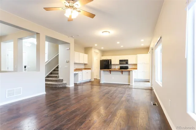 a view of kitchen with furniture and wooden floor