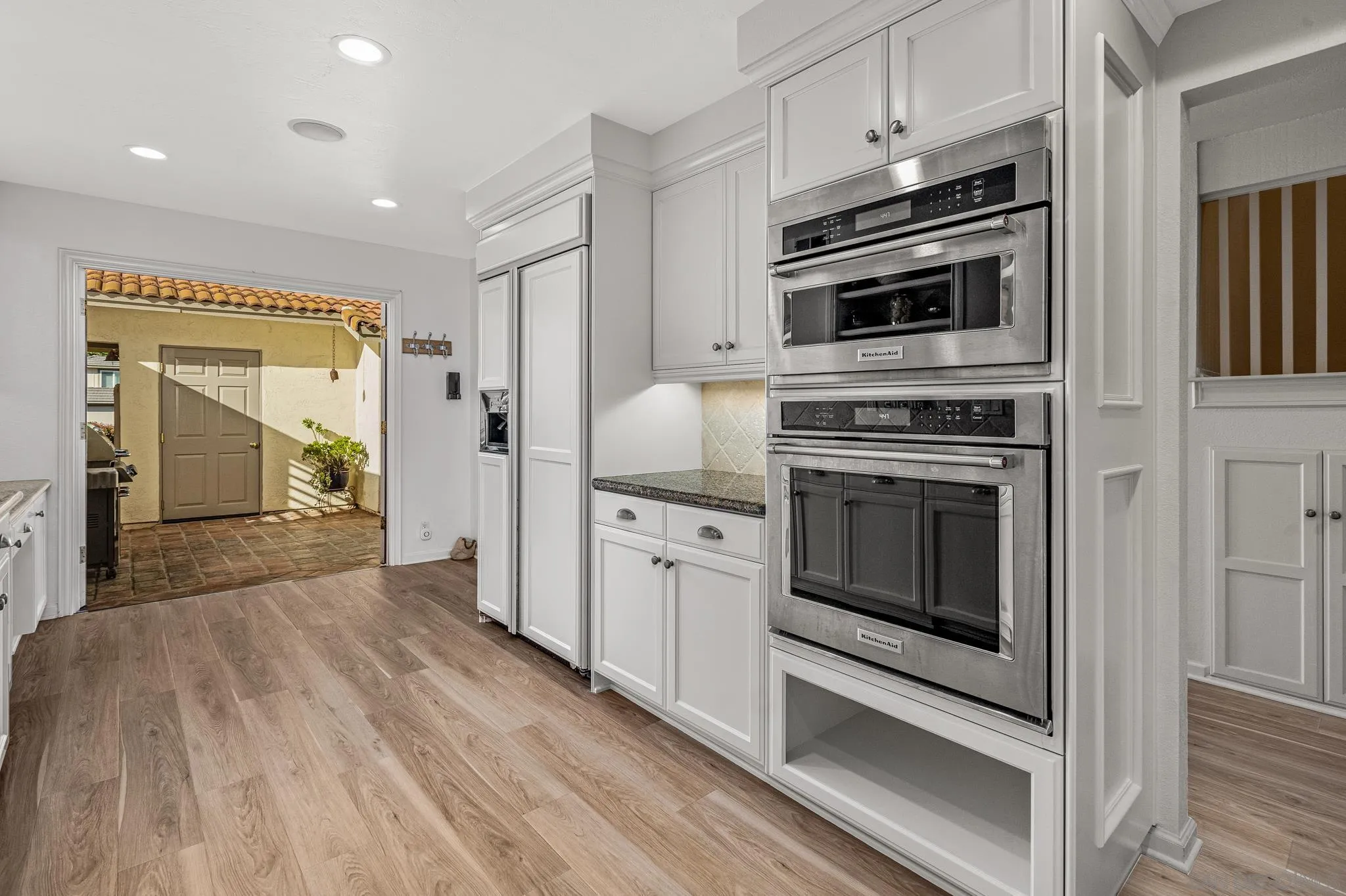 3115 Via De Caballo Encinitas, CA 92024 - Photo 12 of 39 a kitchen with cabinets stainless steel appliances and wooden floor
