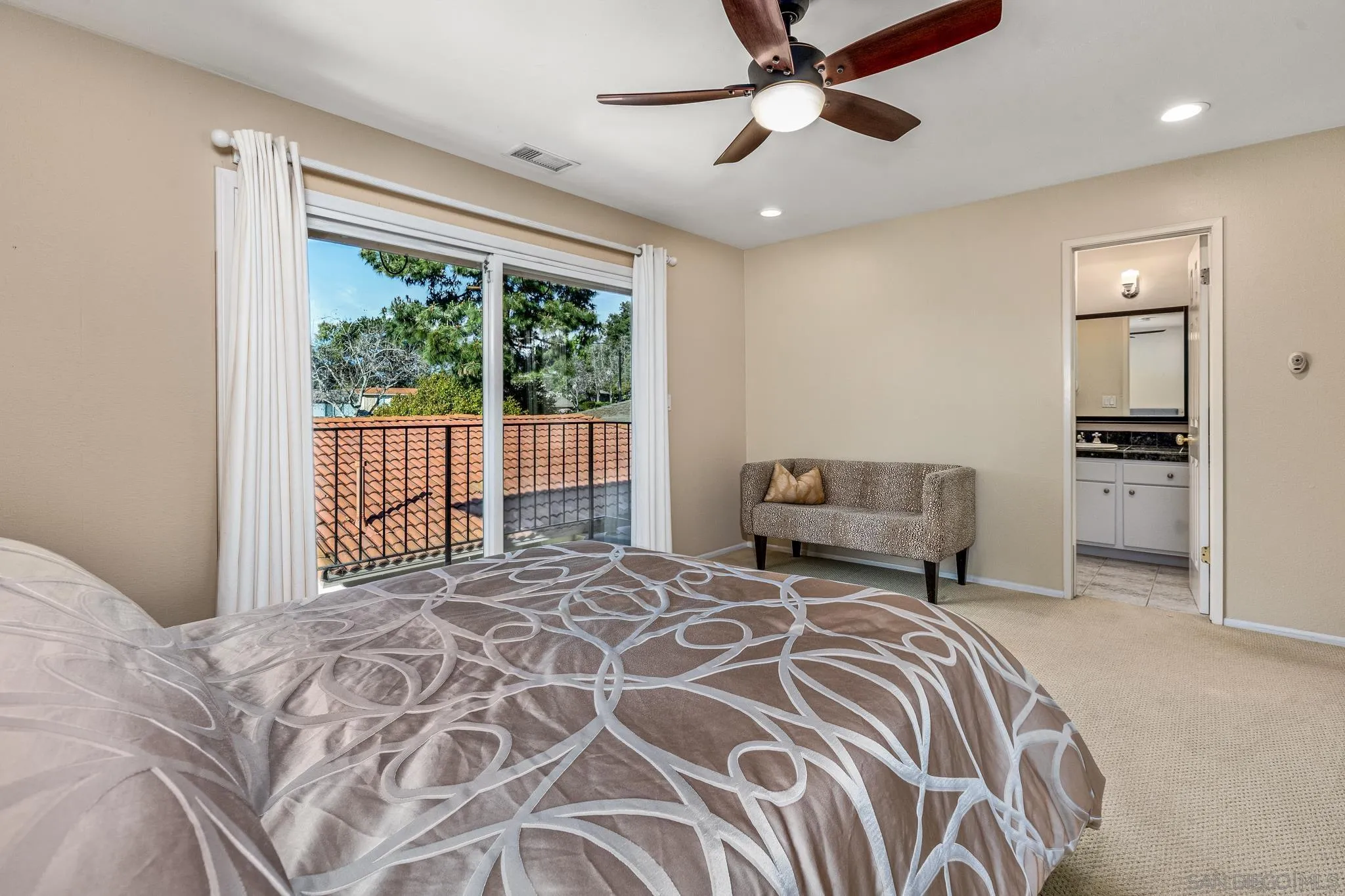 3115 Via De Caballo Encinitas, CA 92024 - Photo 28 of 39 a bedroom with a large bed and a chandelier