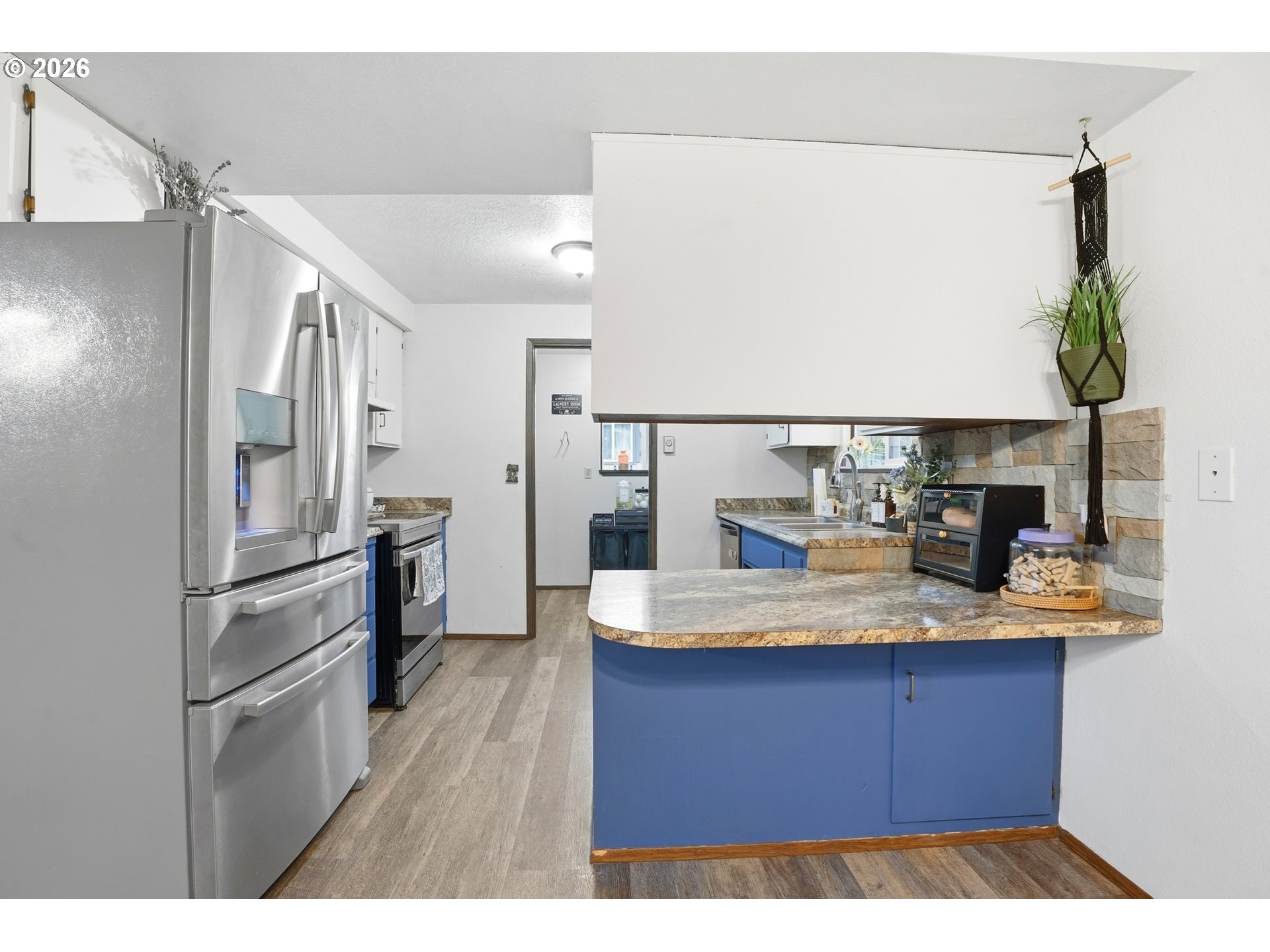 224 6th Street Dayton, OR 97114 - Photo 12 of 37 a kitchen with kitchen island a counter top space wooden floor and stainless steel appliances