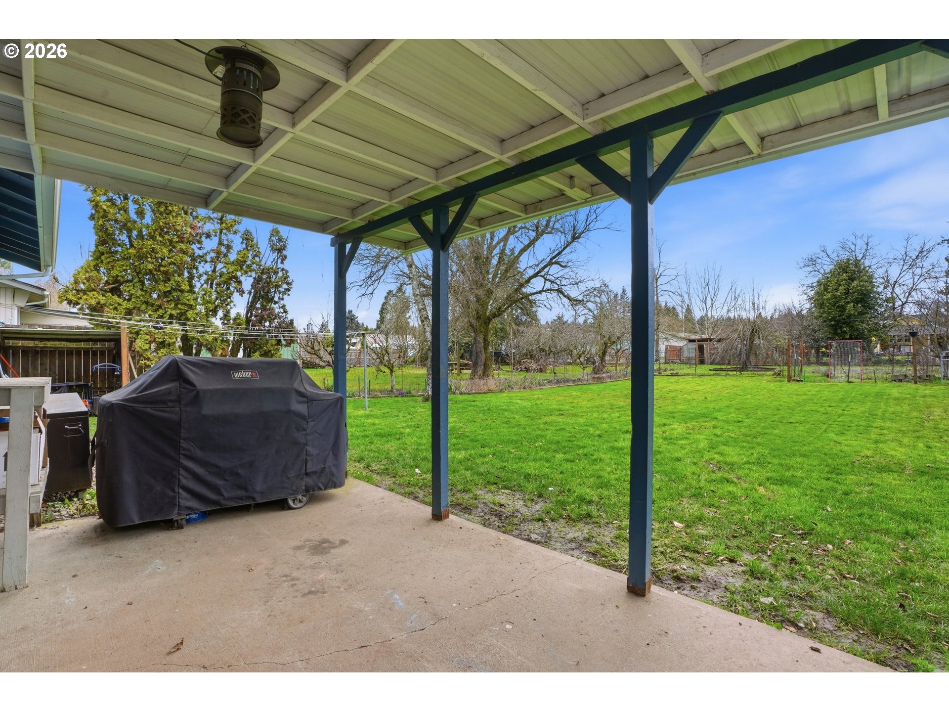 224 6th Street Dayton, OR 97114 - Photo 26 of 37 a view of a backyard with table and chairs under an umbrella
