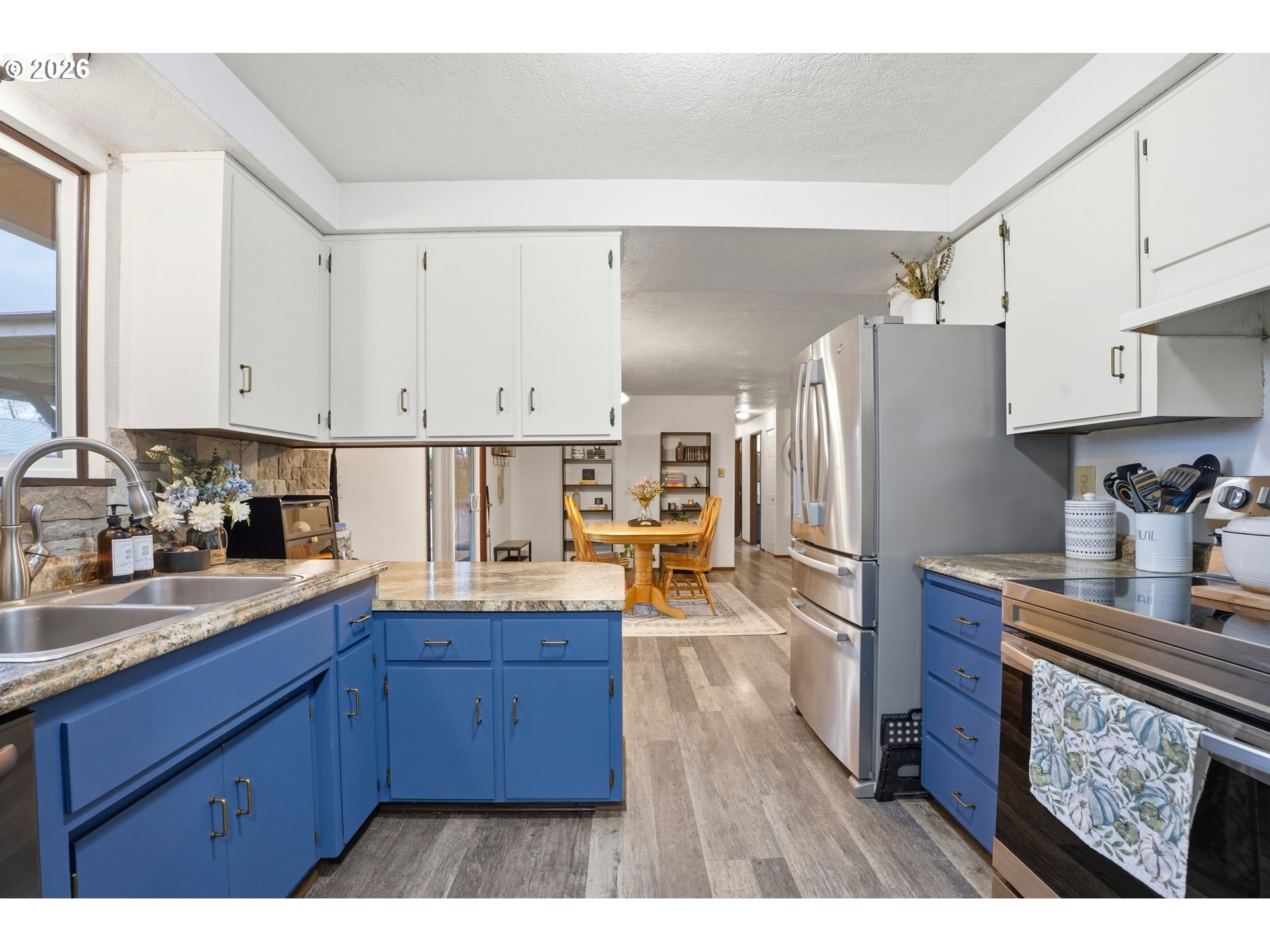 224 6th Street Dayton, OR 97114 - Photo 10 of 37 a kitchen with granite countertop wooden cabinets a sink and dishwasher
