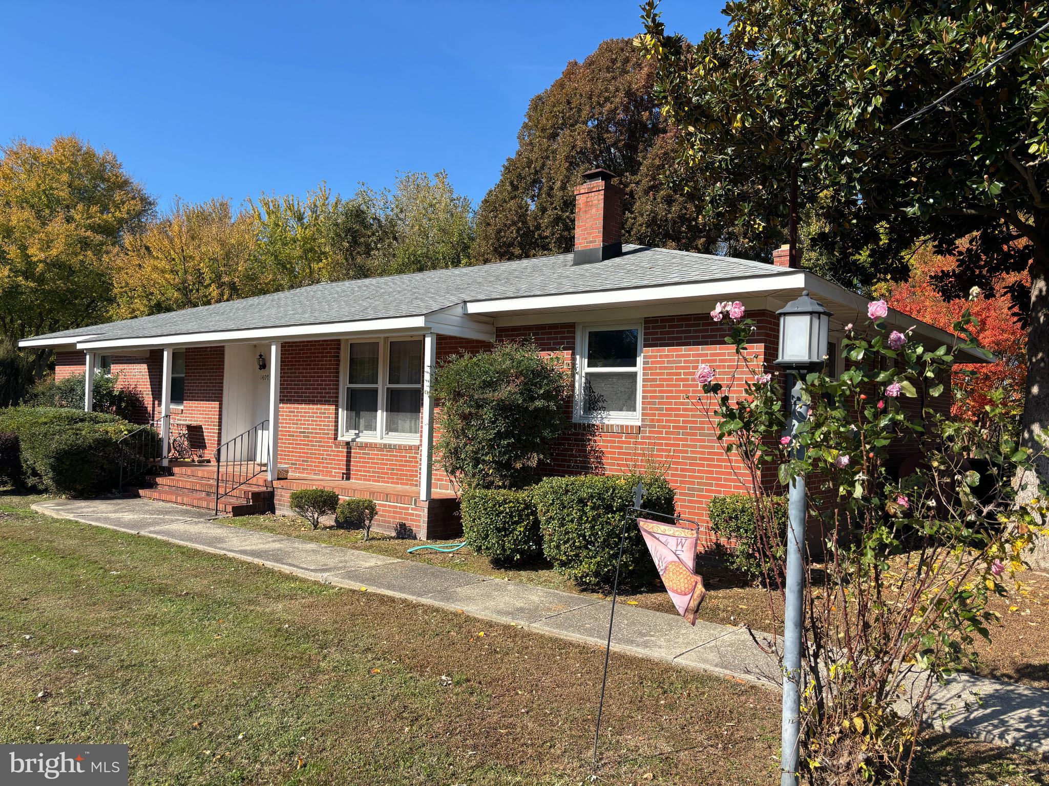a front view of a house with a yard garage and outdoor seating