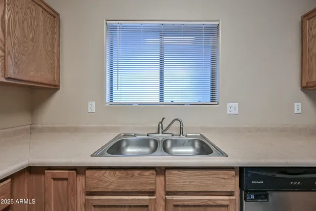 a kitchen with a sink cabinets and a window
