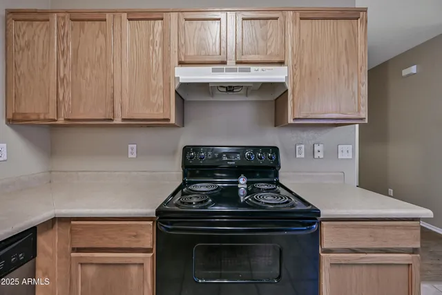 a stove top oven sitting inside of a kitchen