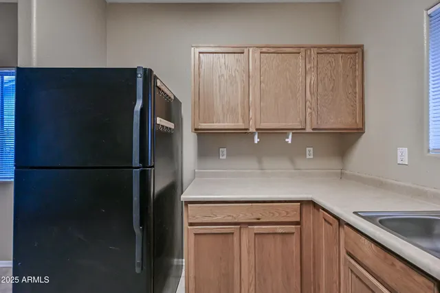 a kitchen with a refrigerator and cabinets