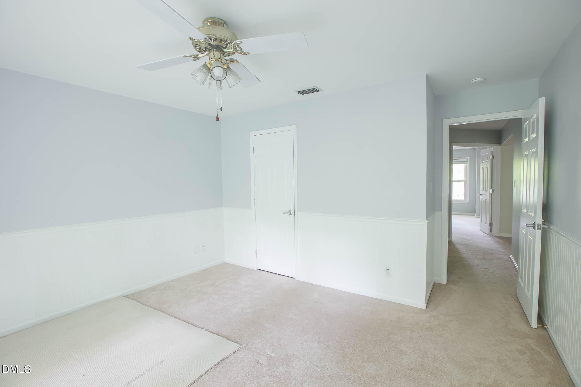 115 Abingdon Court, Unit 2B Cary, NC 27513 - Photo 7 of 9 wooden floor in an empty room with a chandelier fan