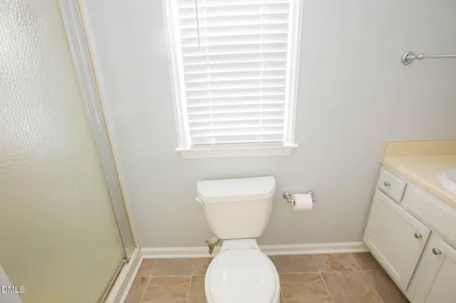 a bathroom with a toilet sink and a window