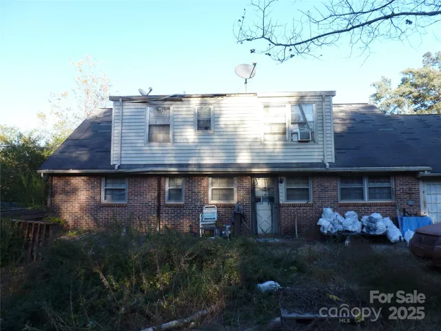 a backyard of a house with barbeque oven