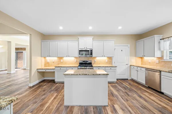 a kitchen with a stove a sink and a refrigerator