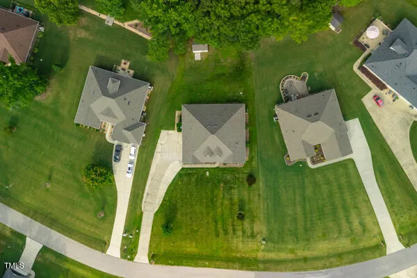 an aerial view of lake residential house with outdoor space and trees around