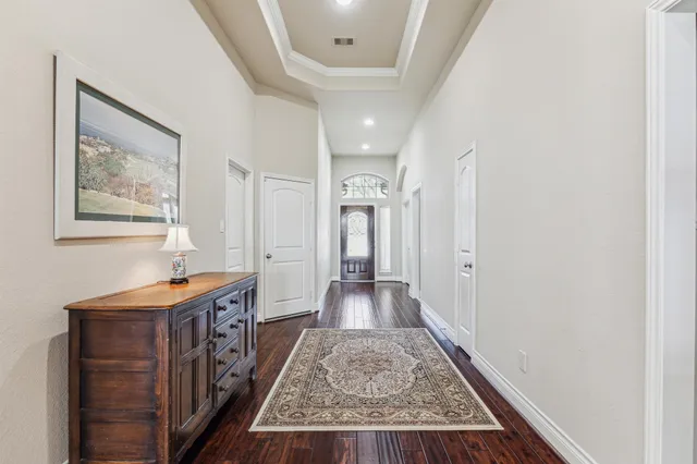 a view of a hallway to a livingroom with furniture