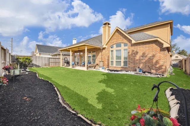 a backyard of a house with table and chairs