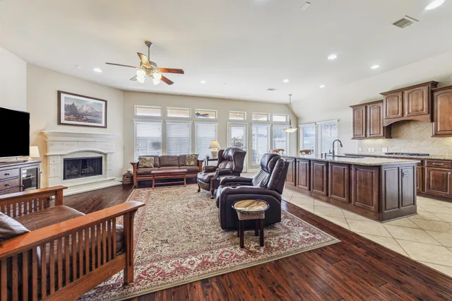 a living room with furniture a fireplace and a flat screen tv