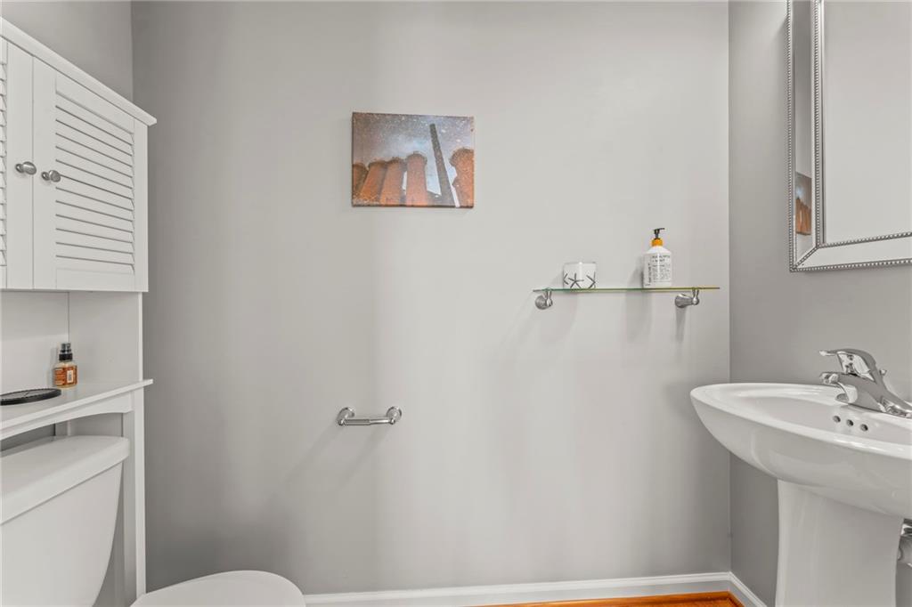 2 Truman Circle McKees Rocks, PA 15136 - Photo 12 of 26 a bathroom with a sink a toilet and mirror