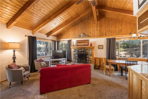a living room with furniture a fireplace and a table