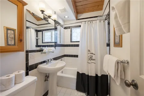 a bathroom with a sink a toilet and shower curtain