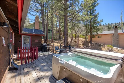 a view of a house with backyard water fountain and sitting area
