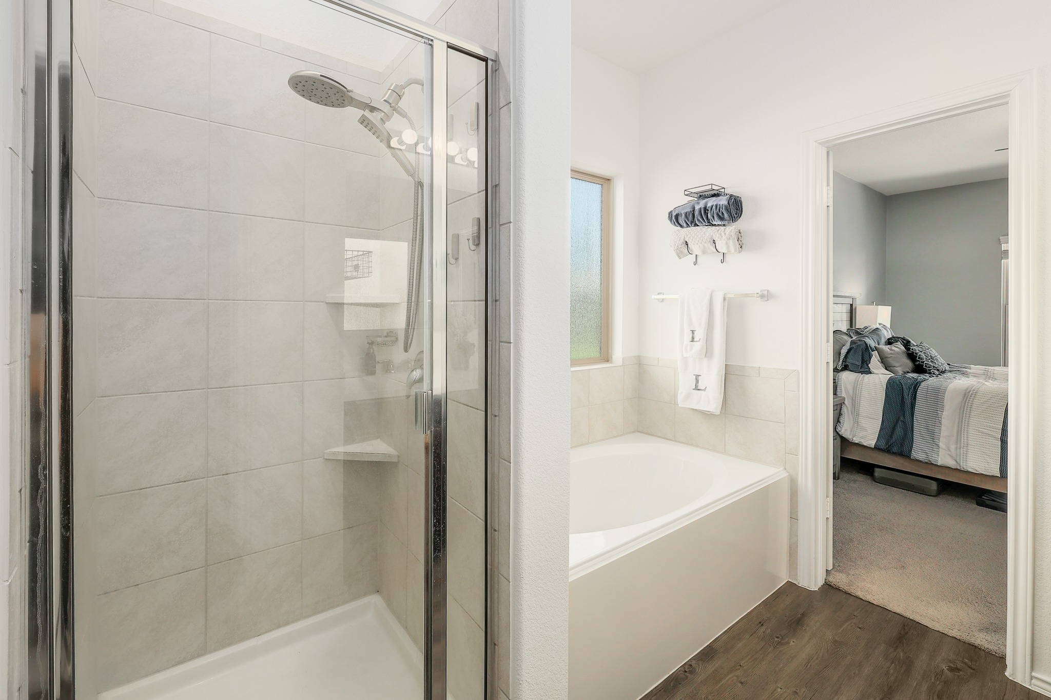 735 Circle Way Jarrell, TX 76537 - Photo 13 of 32 An inviting soaking tub and a walk-in tile shower define this modern bathroom space.