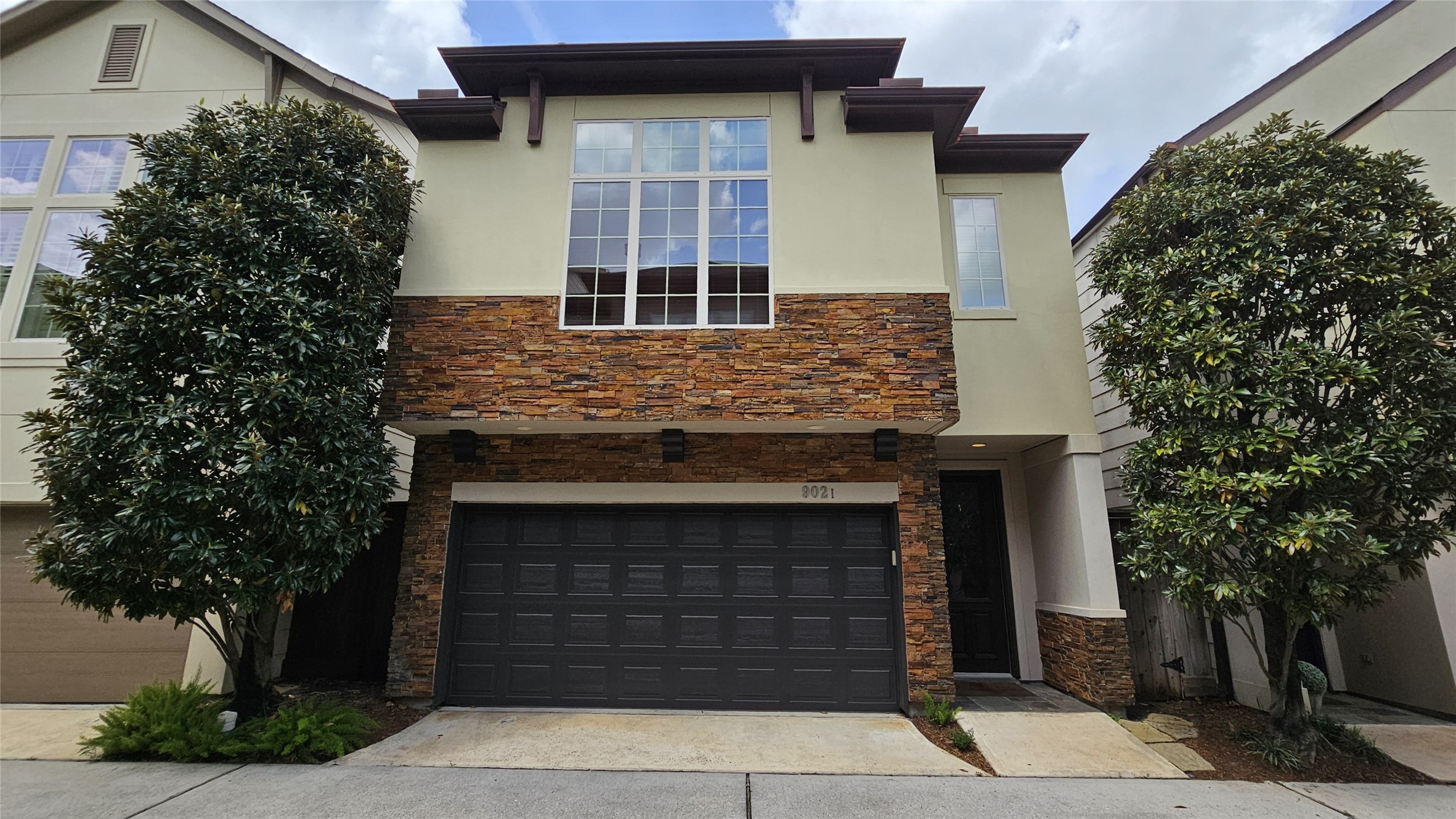 a front view of a house with garage