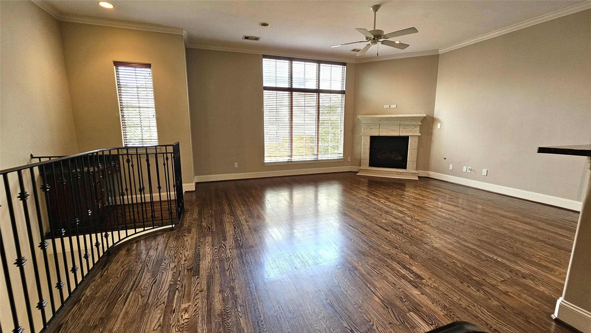 902 West 23rd Street, Unit I Houston, TX 77008 - Photo 2 of 36 an empty room with wooden floor a ceiling fan and windows