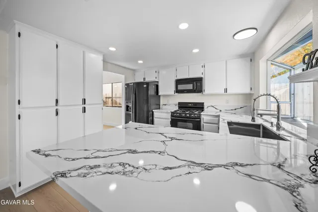 a view of kitchen with stainless steel appliances refrigerator oven and cabinets