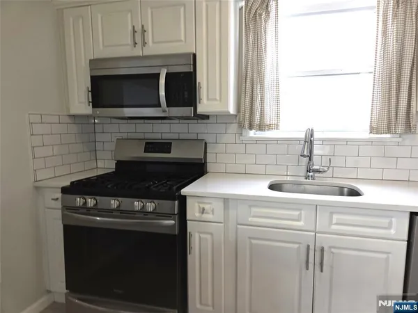 a kitchen with a stove and a microwave