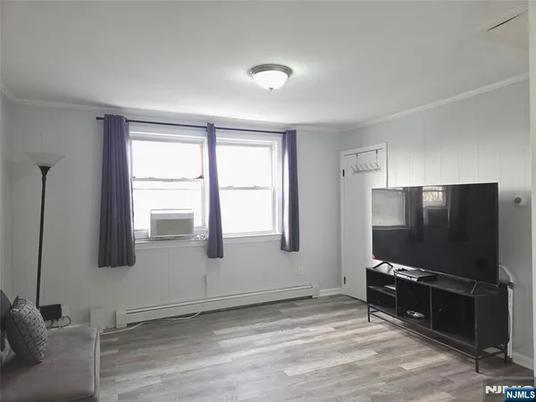 a living room with projector and a flat screen tv