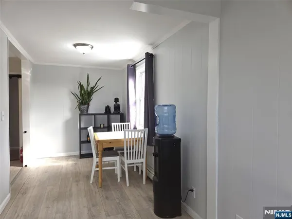 a dining room with furniture and wooden floor