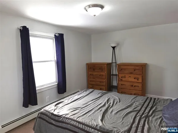 a bedroom with a bed and a television