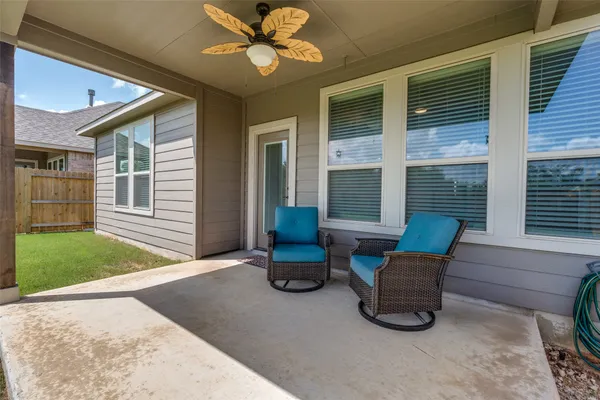a view of a patio with chairs and a yard
