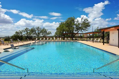 a view of a swimming pool with an outdoor seating