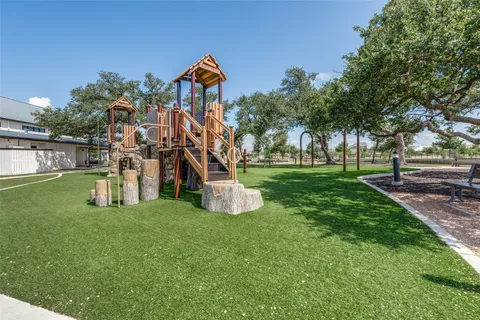 a view of a park with swings and a slide