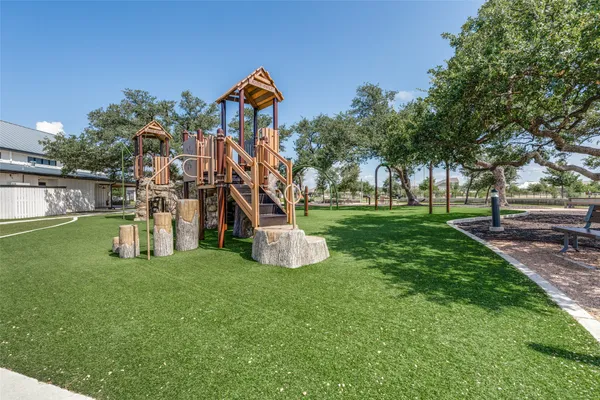 a view of a park with swings and a slide