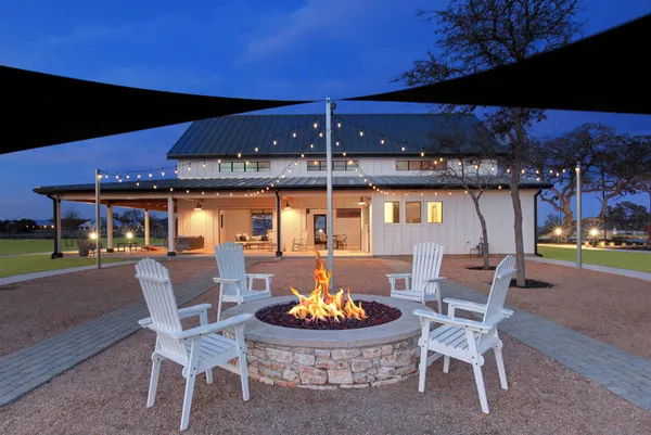 a patio with a table and chairs and a fireplace